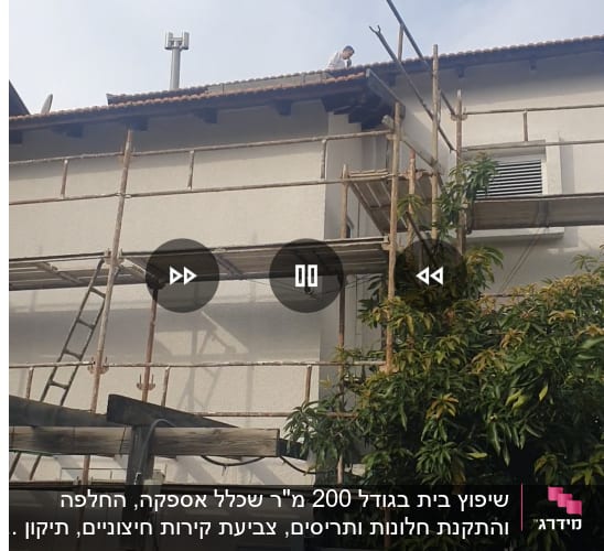 פיגומים לצד בניין עם אדם על הגג